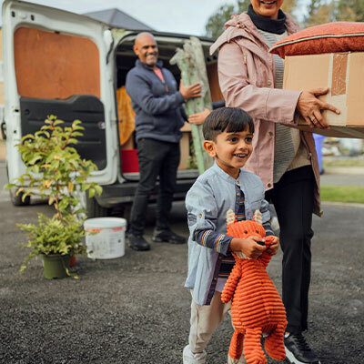 Family unloading their things from a van