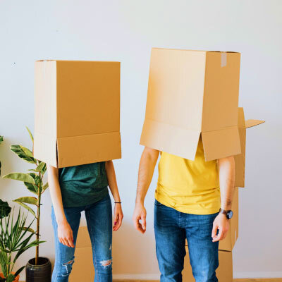 Couple with moving boxes over their heads