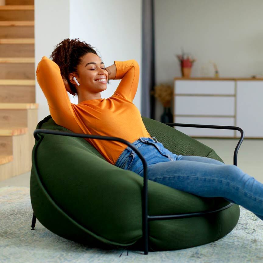 Woman relaxing in new space after storing items