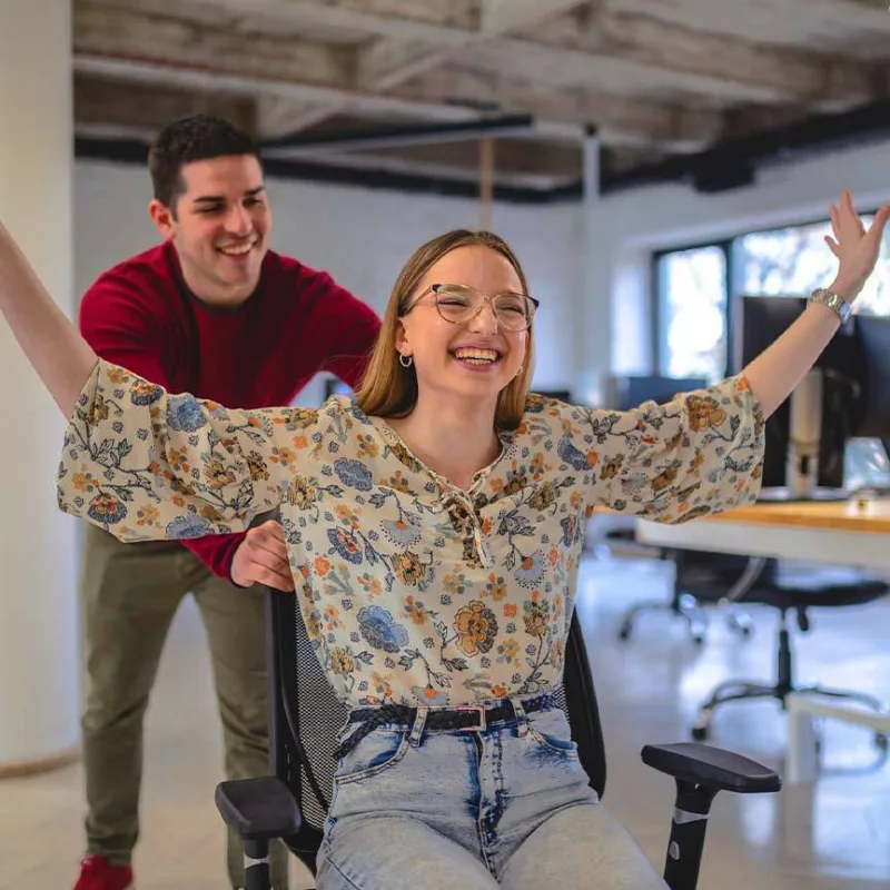 Two colleagues having a laugh in office
